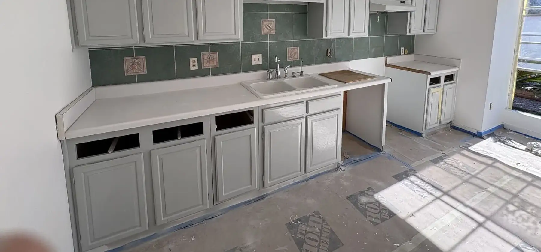 Kitchen mid-renovation on an OAFC Renovations job, cabinets in place and the room stripped back