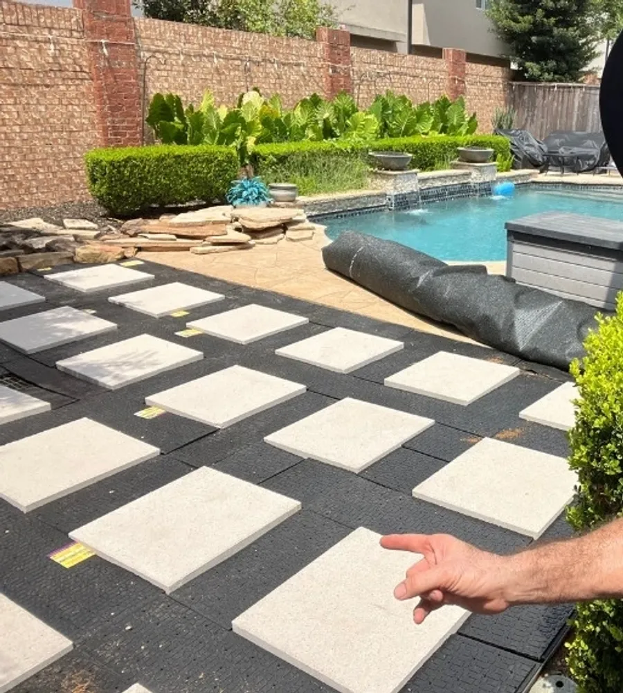 OAFC Renovations owner on a completed artificial grass and paver installation beside a pool